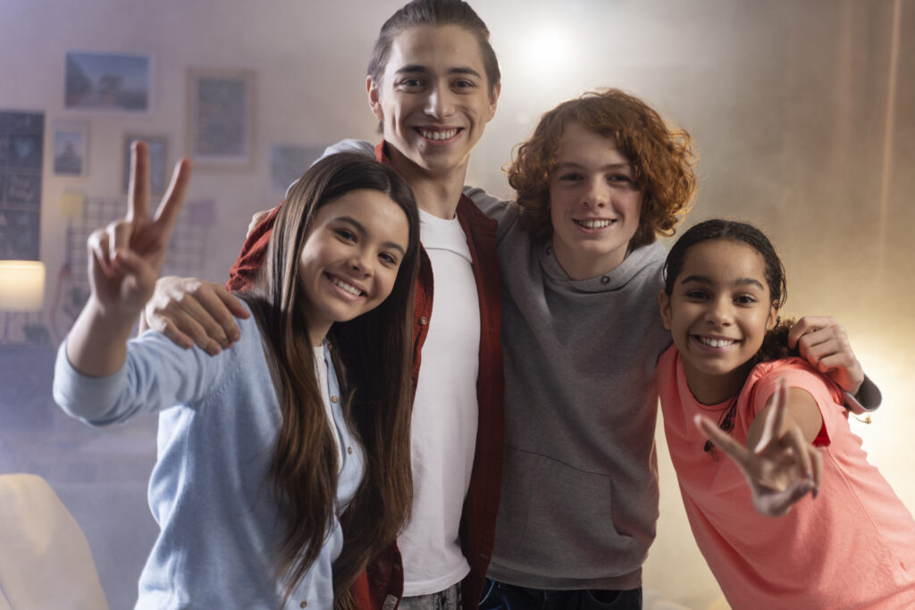 group teenage friends posing together home party